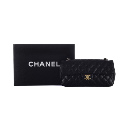 323 - Chanel, a black caviar East West single flap handbag, featuring the maker's iconic black quilted cav... 