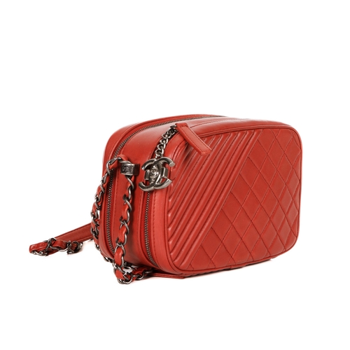 326 - Chanel, a Coco Boy camera bag, featuring a red quilted leather exterior, with antiqued silver-tone h... 