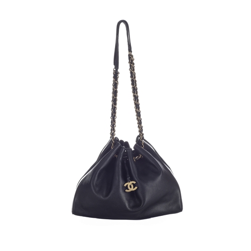 331 - Chanel, a black leather drawstring tote w/pouch, featuring polished gold-tone hardware, concealed ma... 