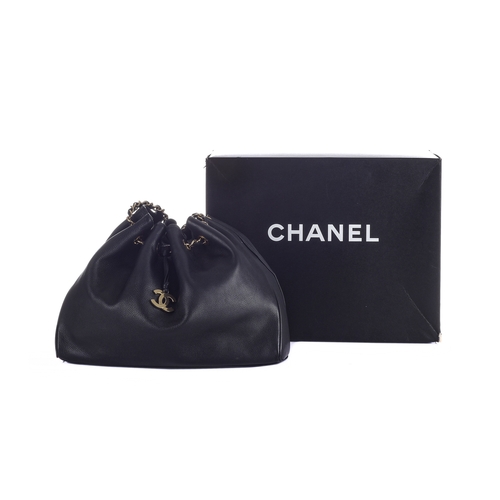 331 - Chanel, a black leather drawstring tote w/pouch, featuring polished gold-tone hardware, concealed ma... 