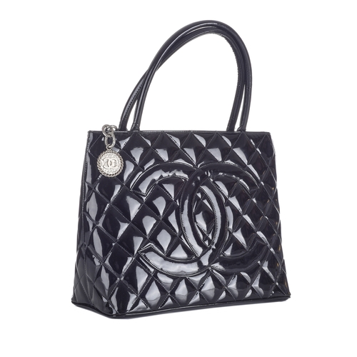 332 - Chanel, a Timeless Medallion tote, crafted from black patent leather with the maker's classic diamon... 