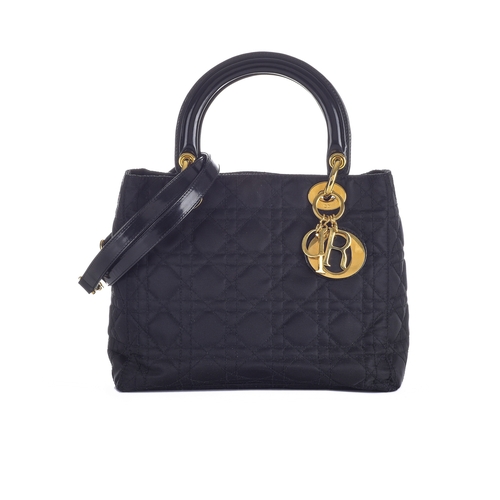 338 - Christian Dior, a black Lady Dior PM handbag, designed with a cannage quilted nylon exterior, with r... 