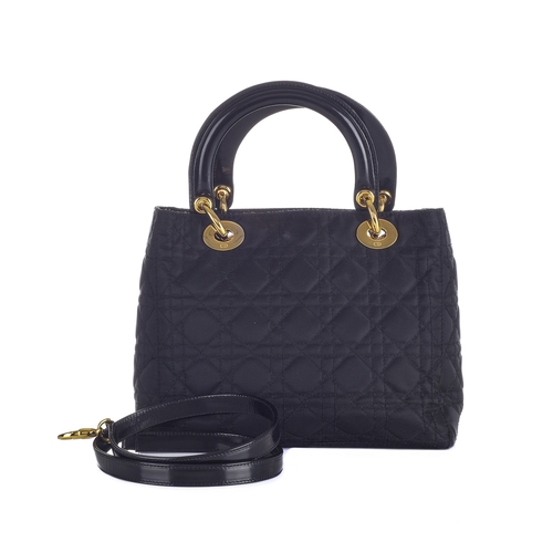 338 - Christian Dior, a black Lady Dior PM handbag, designed with a cannage quilted nylon exterior, with r... 