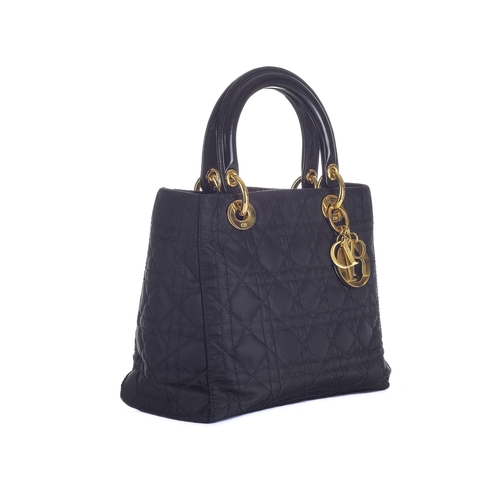 338 - Christian Dior, a black Lady Dior PM handbag, designed with a cannage quilted nylon exterior, with r... 