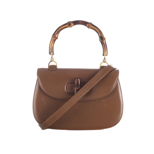 377 - Gucci, a vintage Bamboo Top Handle handbag, crafted from smooth tan leather, featuring a curved bamb... 