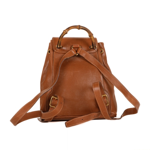 378 - Gucci, a small Bamboo backpack, featuring a smooth tan leather exterior, curved bamboo top handle, f... 