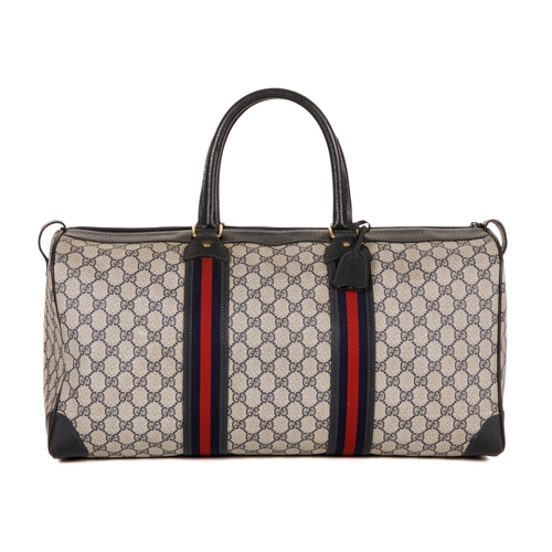 380 - Gucci, a vintage supreme Web travel bag, crafted from the maker's GG coated canvas exterior, with gr... 