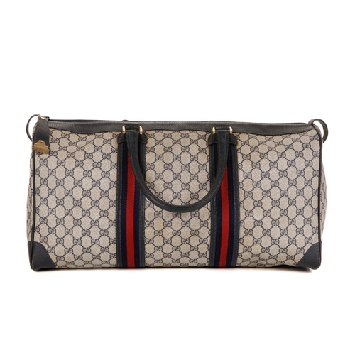 380 - Gucci, a vintage supreme Web travel bag, crafted from the maker's GG coated canvas exterior, with gr... 