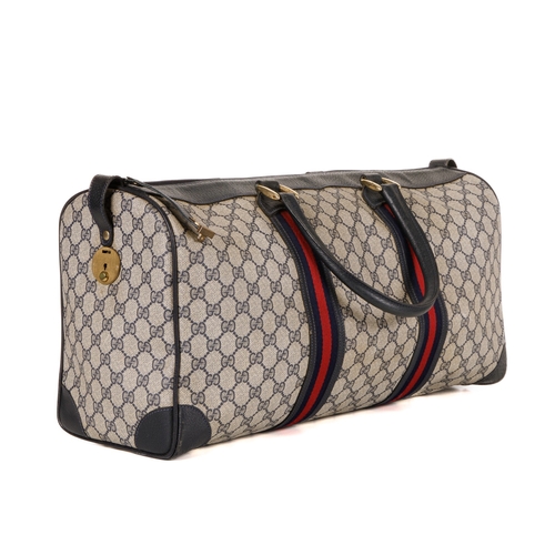 380 - Gucci, a vintage supreme Web travel bag, crafted from the maker's GG coated canvas exterior, with gr... 