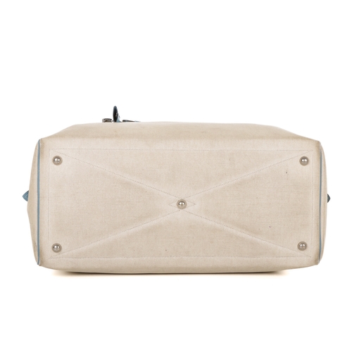 391 - Hermes, a 2000 toile Victora GM 50 travel bag, crafted from cream toile canvas with blue leather tri... 