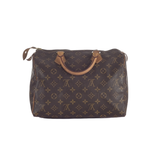 429 - Louis Vuitton, a monogram Speedy 30 handbag, designed with a monogram coated canvas exterior, two va... 