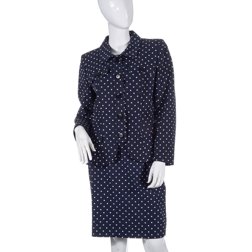 488 - Yves Saint Laurent, a navy blue and white polka dot skirt suit, comprising a fitted jacket with fron... 