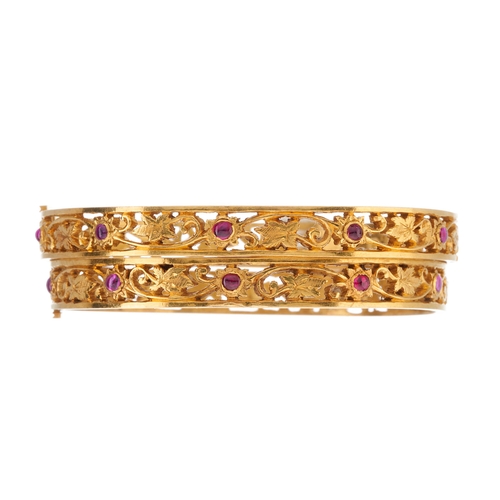 49 - Two gold foliate openwork bangle bracelets, with pink paste cabochon highlights, inner diameter 5.3c... 