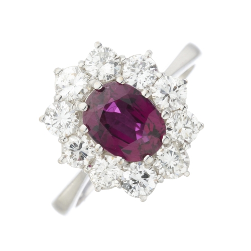 50 - An 18ct gold oval-shape ruby and brilliant-cut diamond cluster ring, ruby estimated weight 1.20ct, e... 