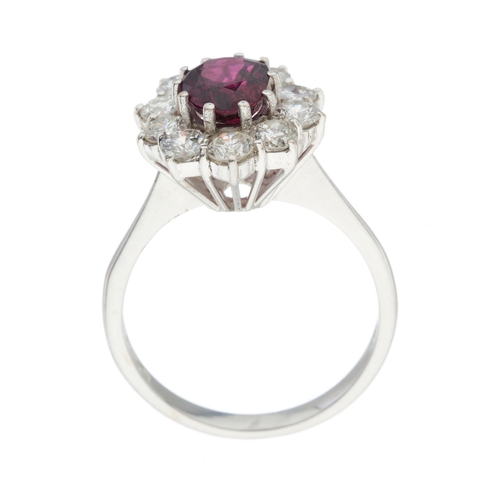 50 - An 18ct gold oval-shape ruby and brilliant-cut diamond cluster ring, ruby estimated weight 1.20ct, e... 