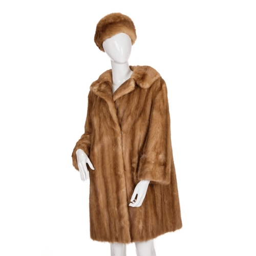 511 - A pastel mink coat with hat, featuring a notched lapel collar, hook and eye fastenings, cocktail cuf... 