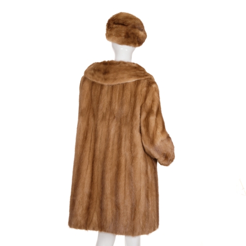 511 - A pastel mink coat with hat, featuring a notched lapel collar, hook and eye fastenings, cocktail cuf... 