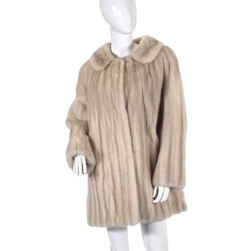 512 - Arnold Sefton, a pearl mink coat, fully stranded, featuring a notched lapel collar, hook and eye fas... 