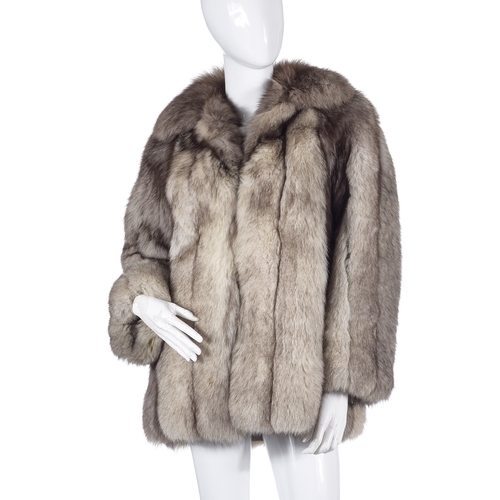 514 - A blue fox fur jacket, featuring a lapel collar, hook and eye fastenings and two outer pockets, ches... 