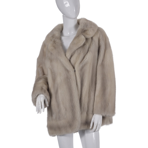 516 - An azurene mink fur jacket, featuring a notched lapel jacket, hook and eye fastenings and two outer ... 