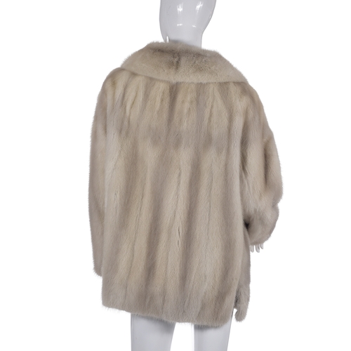 516 - An azurene mink fur jacket, featuring a notched lapel jacket, hook and eye fastenings and two outer ... 