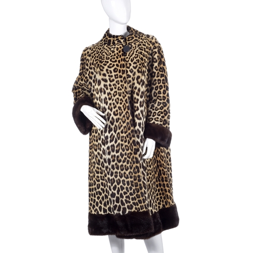 518 - Calman Links, a 1950s leopard fur coat with mink fur trim, designed with a short Mandarin collar, ra... 