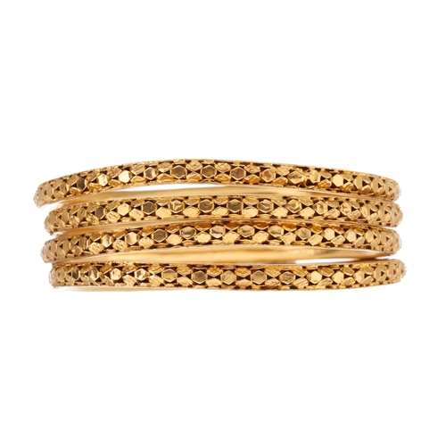 52 - Four 18ct gold bangle bracelets, of pierced design, inner diameter 6cm each, 71.4g