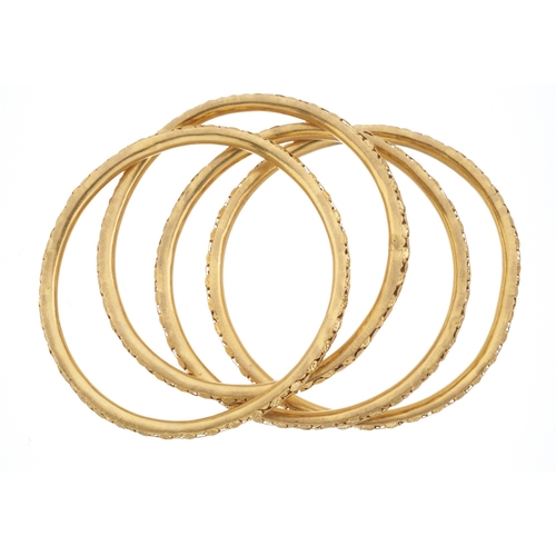 52 - Four 18ct gold bangle bracelets, of pierced design, inner diameter 6cm each, 71.4g