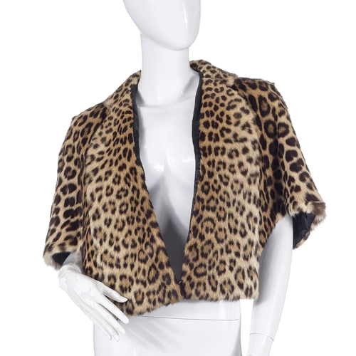 520 - A 1960s leopard fur cape, with a long-panelled collar and wide lapel that provides pocket features, ... 