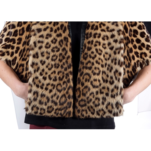 520 - A 1960s leopard fur cape, with a long-panelled collar and wide lapel that provides pocket features, ... 