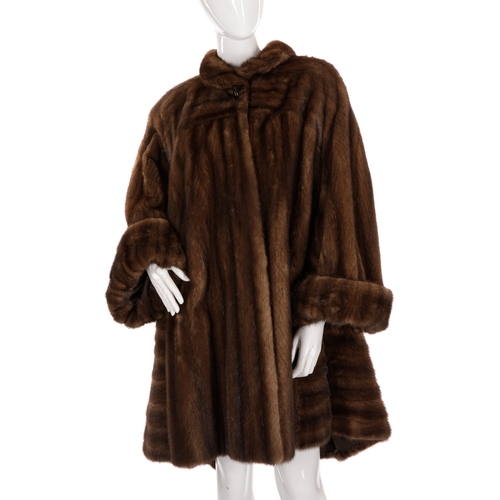 523 - Revillon, a knee-length ranch mink swing coat, featuring a short collar with large button detail, wi... 