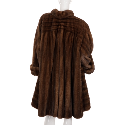 523 - Revillon, a knee-length ranch mink swing coat, featuring a short collar with large button detail, wi... 