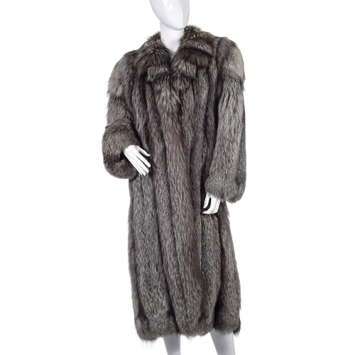 524 - A full-length silver fox fur coat, featuring a notched lapel collar, hook and eye clip fastenings, t... 