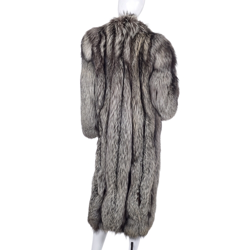 524 - A full-length silver fox fur coat, featuring a notched lapel collar, hook and eye clip fastenings, t... 