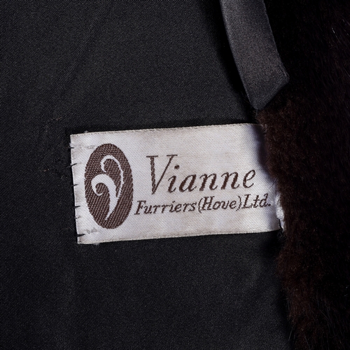 525 - London Label, a full-length dark ranch mink coat, fully stranded, featuring a lapel collar, hook and... 