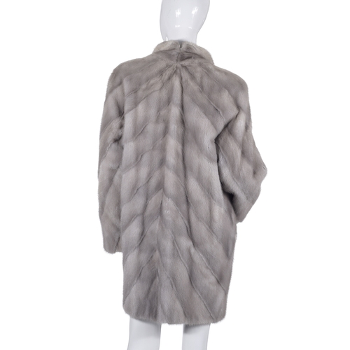 527 - Sergio Soldano, a sapphire mink coat, designed with diagonal pelts, with a thin lapel collar, hook a... 