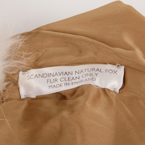 530 - A golden and white fox fur gilet, featuring hook and eye clip fastenings, two outer pockets and two ... 