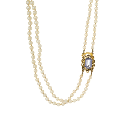 69 - A mid 20th century graduated pearl two-row necklace, gathered to a gold sapphire single-stone clasp,... 