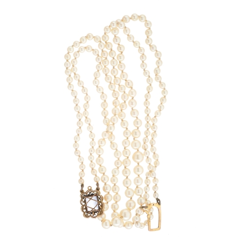 69 - A mid 20th century graduated pearl two-row necklace, gathered to a gold sapphire single-stone clasp,... 