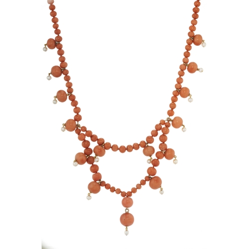 75 - An early to mid 20th century coral bead fringe necklace, with seed pearl drop highlights, wearable l... 