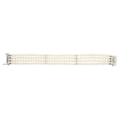 81 - A mid 20th century pearl four-row bracelet, with white metal pearl accent sliding clasp and bar spac... 