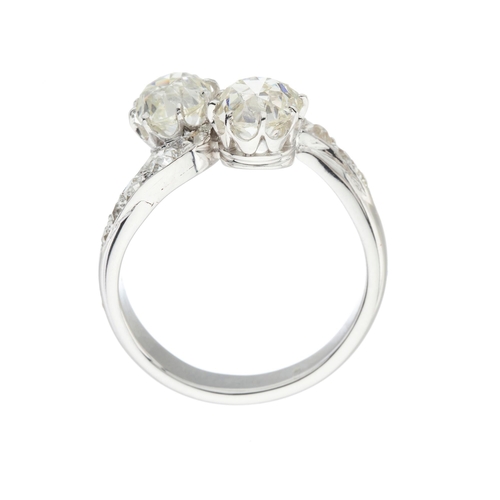 87 - A mid 20th century gold old-cut diamond two-stone crossover ring, with similarly-cut diamond line si... 