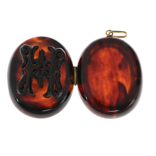 13 - A late Victorian tortoiseshell locket pendant, with scrolling overlay and glazed insert, length 5cm,... 