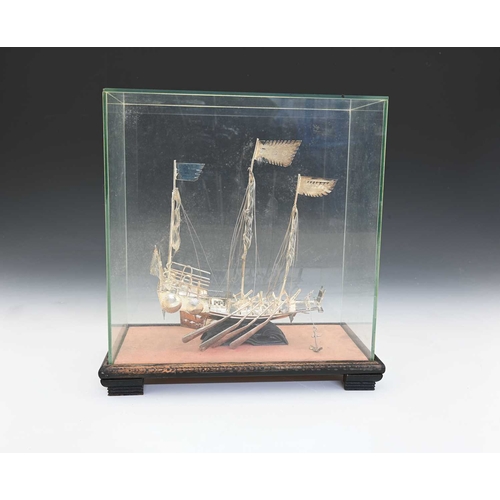 135 - A Chinese silver-coloured metal model of a sailing ship or a junk, ensuite with rigging and sails, w... 