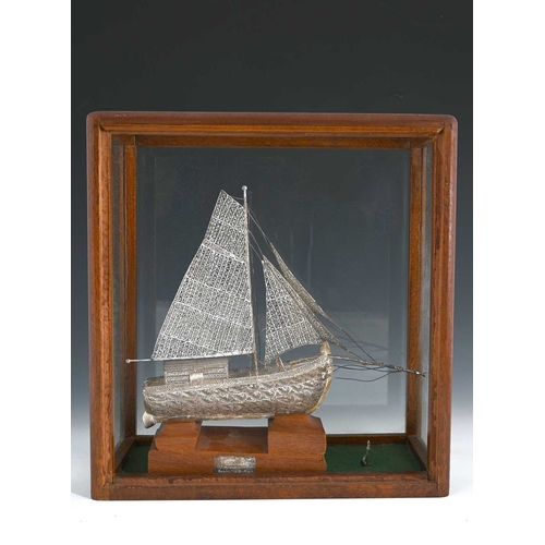 136 - Harold Wilson interest, a silver filigree model ship, made by Mr. M. Lowe, atop a wood plinth, with ... 