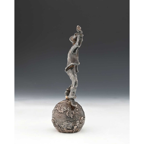 137 - Judaica, a twentieth-century silver-coloured metal figure, atop a sphere decorated in relief, inscri... 