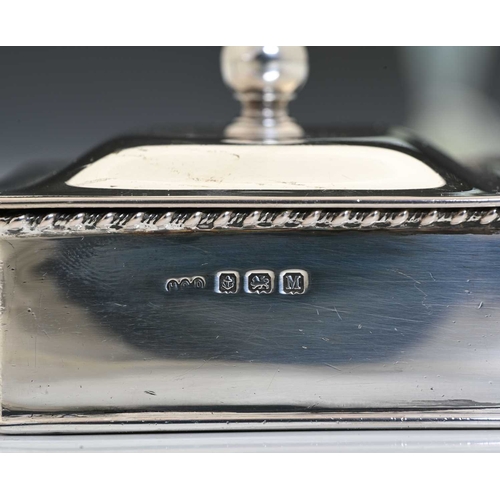 150 - An Edward VIII silver 'silent butler', with turned wood handle, the hinged cover with spherical fini... 