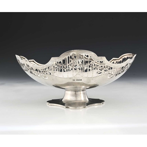 170 - A George V silver pedestal basket, of navette form, with a pierced border depicting foliate garlands... 