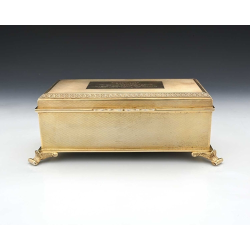 177 - An Elizabeth II silver gilt jewellery casket, the exterior decorated with engine turning, the hinged... 