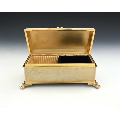 177 - An Elizabeth II silver gilt jewellery casket, the exterior decorated with engine turning, the hinged... 